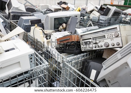 Electronic devices dump site. E-waste disposal, management, reuse, recycle and recovery concept. Electronic consumerism, globalization, raw material source concept. 
