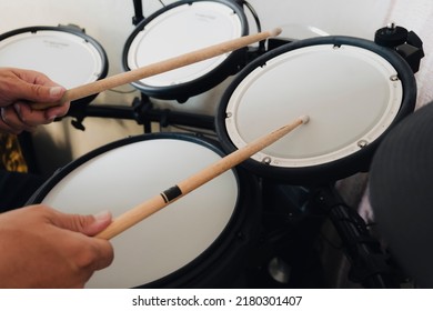 electronic drumsticks and drums on a dark background. Playing the training drums.