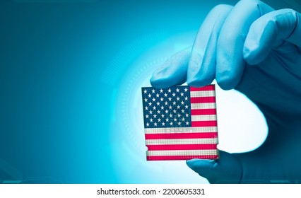 Electronic Engineer Hand Holding Computer Chip With American Flag On Blue Background. Chipset Of Electronic Circuit Board. CPU Chip. Computer Hardware. Computer Processor Chip. American Computer Chip.