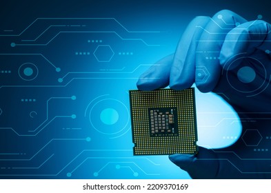 Electronic Engineer Hand Holding Computer Chip On Blue Background. Chipset Of Electronic Circuit Board For PC Motherboard. CPU Chip. Electronic Components. Computer Hardware. Computer Processor Chip.