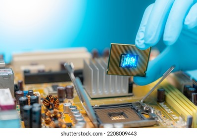 Electronic engineer hand putting computer chip on socket. Chipset on electronic circuit board of PC mother board. CPU chip. Electronic components. Computer hardware. Upgrade computer processor chip.
