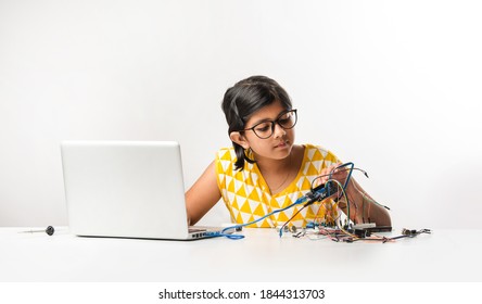 Electronic Experiment - Asian Indian Small Girl Student Performing Or Studying Science With Wires, Connections, Studying From Laptop Or Tablet Computer