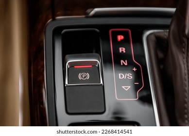 Electronic handbrake button. Gear shift stick into P position, (parking) symbol in automatic transmission car. Modern automatic gearbox car. Car detailing. Interior car inside. handle closeup.