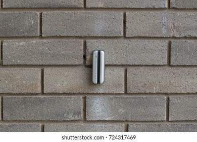 Electronic keycard reader on a brick wall