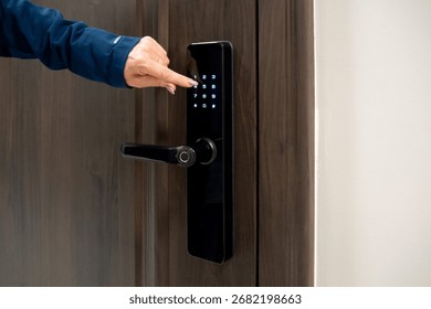 Electronic lock system for secure access control. Smart door lock with keypad and hand entering code. Hand dials the lock code. Real photo