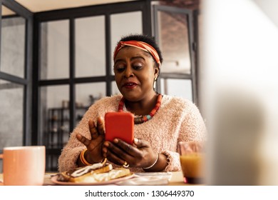 Electronic mail. Happy joyful woman using her smartphone while checking her mailbox - Powered by Shutterstock