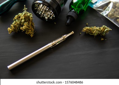 Electronic Marijuana Vaporizer Medical Marijuana. Сannabis Extract Vape THC Oil. Cannabis OIL Close Up. Weed On Black Background. Product Of Pot.