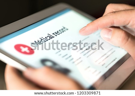 Electronic medical record with patient data and health care information in tablet. Doctor using digital smart device to read report online. Modern technology in hospital.