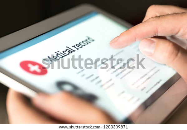 Electronic medical record\
with patient data and health care information in tablet. Doctor\
using digital smart device to read report online. Modern technology\
in hospital.