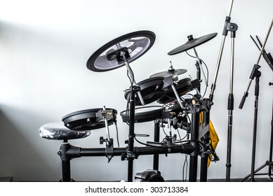 Electronic Modern Drum Kits Set In A Small Music Room With White Wall