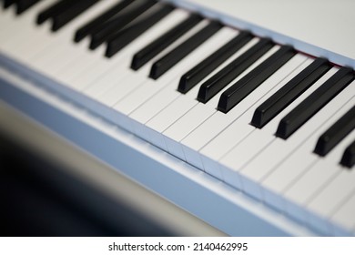 Electronic Musical Keyboard Synthesizer Close-up. White Synthesizer Keyboard. Studio Music Synthesizer Keyboard. Black And White Keys On Analog Synth Device For Electronic Musical Production