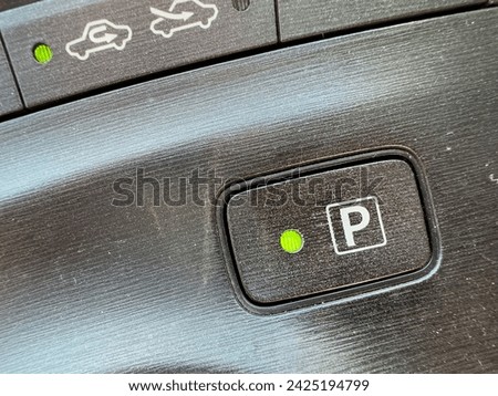Electronic parking P symbol in automatic transmission vehicle closeup.
