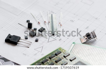 Electronic parts on the background of the schematic diagram. Diodes, microchips, transistors, integrated circuits, capacitors.Design of electronic circuit and electronic Board.Connection diagram