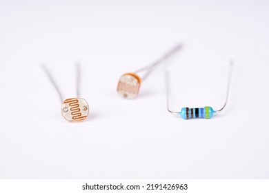 Electronic Parts Photoresistor And Resistor On The White Background.