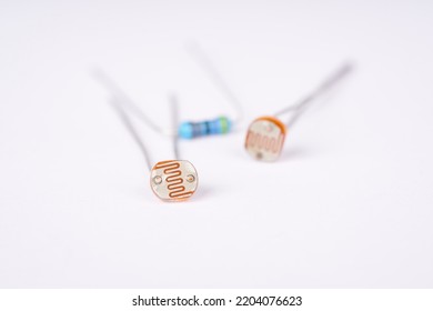 Electronic Parts Photoresistor And Resistor On The White Background.