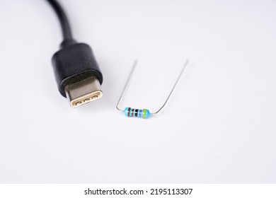 Electronic Parts Resistor And USB Cable Connector C On The White Background.