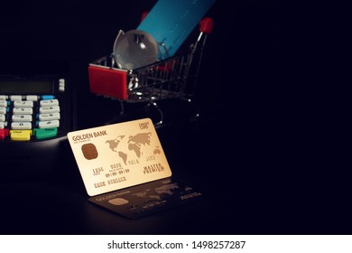 electronic payment device reader machine, gold premium credit card of digital banking investment financial and money concept on black background and shopping cart