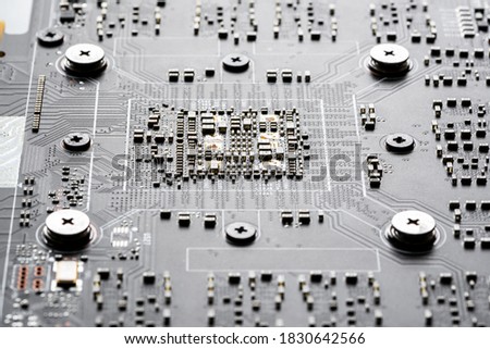 Electronic PCB printed circuit board in macro close-up with transistors circuitry and electric hardware elements, visible computer chips