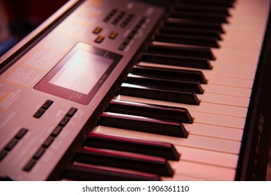 Electronic Piano Keyboard, Organ in Reddish Hue - Shutterstock ID 1906361110