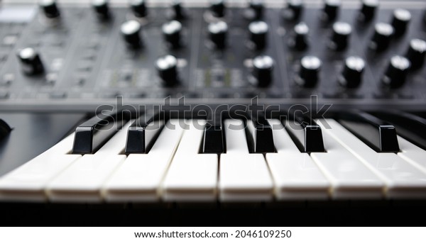 Electronic piano\
synthesizer keyboard. Black and white keys on analog synth device\
for electronic musical\
production