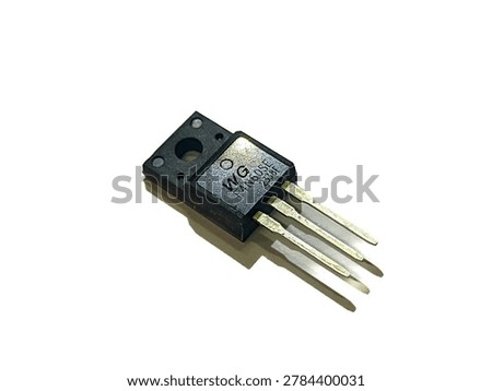 Electronic power transistor component with three pins isolated on white background. Semiconductor MOSFET for circuit board. Three-pin voltage regulator integrated circuit chip on white backdrop. Hardware element for electric power supply repair.