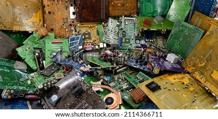 Electronic printed circuit boards in an electronics dump. A bunch of non-working motherboards to hand over to the scrap, for recycling. Concept - Purchase of electronic PC scrap.