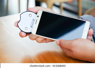 Electronic Queue Pager On Businessman Hand