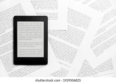 Electronic reader with the screen on and a text on it, on sheets of paper with text printed on them. Concepts: reading and digital technology. Flat lay image with copy space.