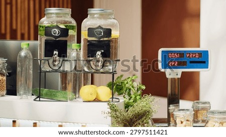 Electronic scale in eco friendly zero waste supermarket next to freshly harvested produce, panning shot of weighing machine in green living local shop used for bulk products.