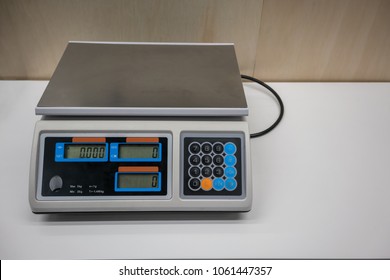 Electronic Scales for weighing food or candy in front of wooden wall