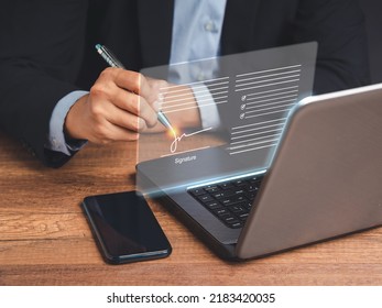 Electronic signature. A businessman in a suit uses a pen to sign electronic documents on digital documents on a virtual screen. Technology, document management, and paperless office concept