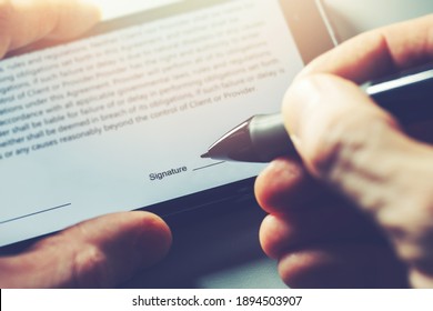 electronic signature concept - man sign distance contract with digital pen in mobile phone - Shutterstock ID 1894503907