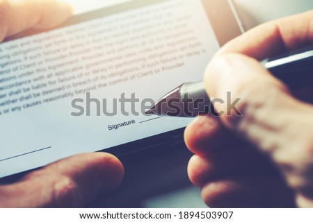 electronic signature concept - man sign distance contract with digital pen in mobile phone
