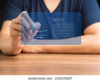 Electronic signature and paperless office concept. Man in casual uses a pen to sign electronic documents on digital documents on a virtual screen. E-signing. Technology and document management - Shutterstock ID 2143191837