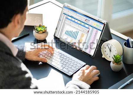 Electronic Spreadsheet Analyst Or Auditor Using Software On Hybrid Laptop