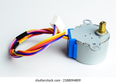 Electronic stepper motor with colorful wires on a white background. Macro photo. Background picture.
