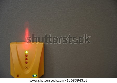 Electronic stud finder with indicator light
