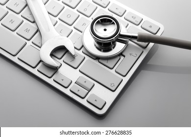 Electronic Technical Support Concept - Spanners On Computer Keyboard