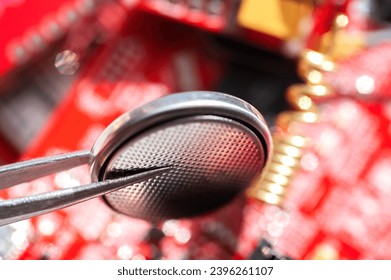 Electronic technician holding tweezers with microchip and assemblin a circuit board. Production computer or repair pc system. Selective focus. - Shutterstock ID 2396261107