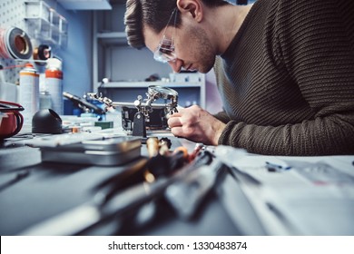 Electronic Technician Working In The Modern Repair Shop