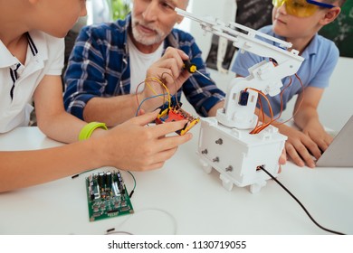 Electronic technology. Close up of an electronic scheme being in hands of a nice positive boy