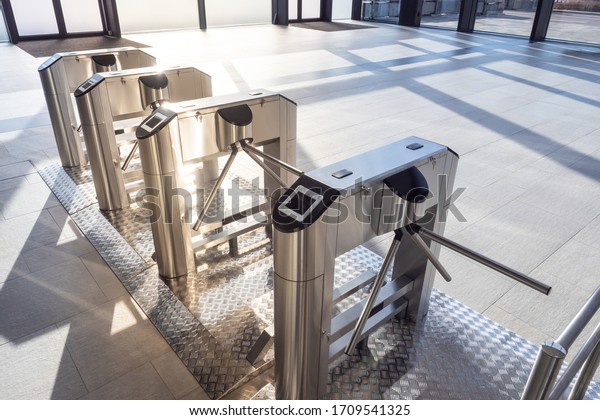 Electronic turnstile. Access system to the\
building. Pass through the passes. Security systems for rooms.\
Several turnstiles are installed nearby. Check Point. Automatic\
checkpoint. Building\
security.