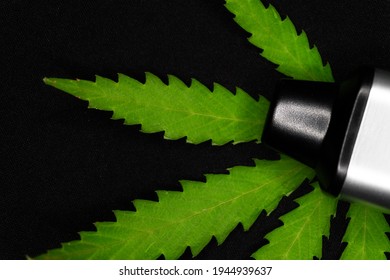 Electronic Vaporizer With Cannabis Leaf On Black Background