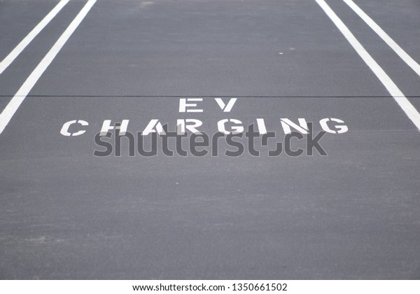 Electronic Vehicle Charging Station sign in\
horizontal angle with clear blue sky in\
USA