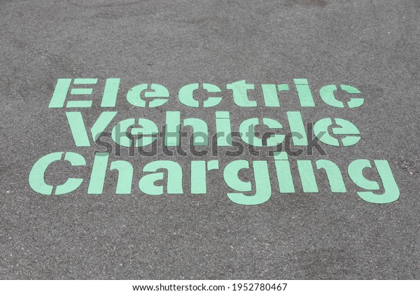 Electronic Vehicle Charging Stenciled Painting on the\
Ground 