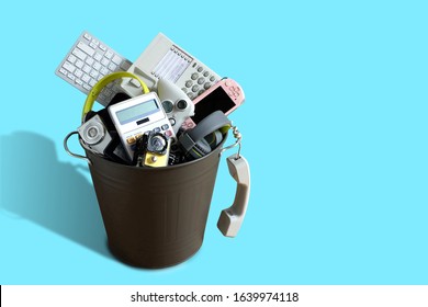 Electronic Waste Broken Or Damage In Dustbin Isolated On Blue Background And Leave Blank Space Above For Text Input, Reuse And Recycle Concept.