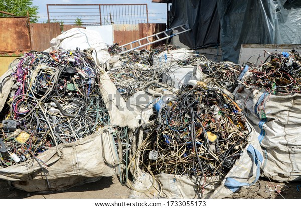 Electronic\
waste ready for recycling. Metal pile of scrap copper electrical\
cable. Secondary raw materials. Iron raw materials. Close up of\
metal waste junkyard. Collected scrap metal.\
