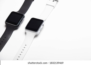 Electronic wrist watch on a white background . White and black wrist watches. Women's and men's watches. Isolated background. Article about modern watches. Article about choosing a watch.