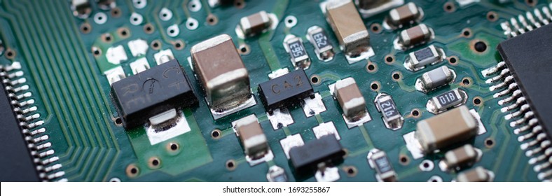 Electronics. Back of a traditional HDD details macro closeup chips resistors capacitors and other microelectronics printed circuit