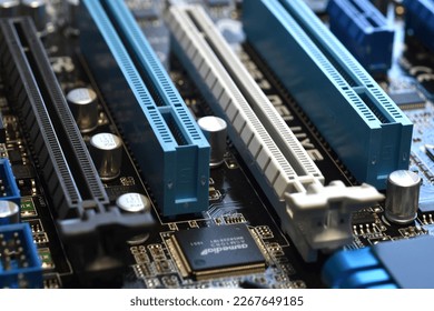Electronics Components on a Modern PC Computer Motherboard with PCI and PCI-Express slot.